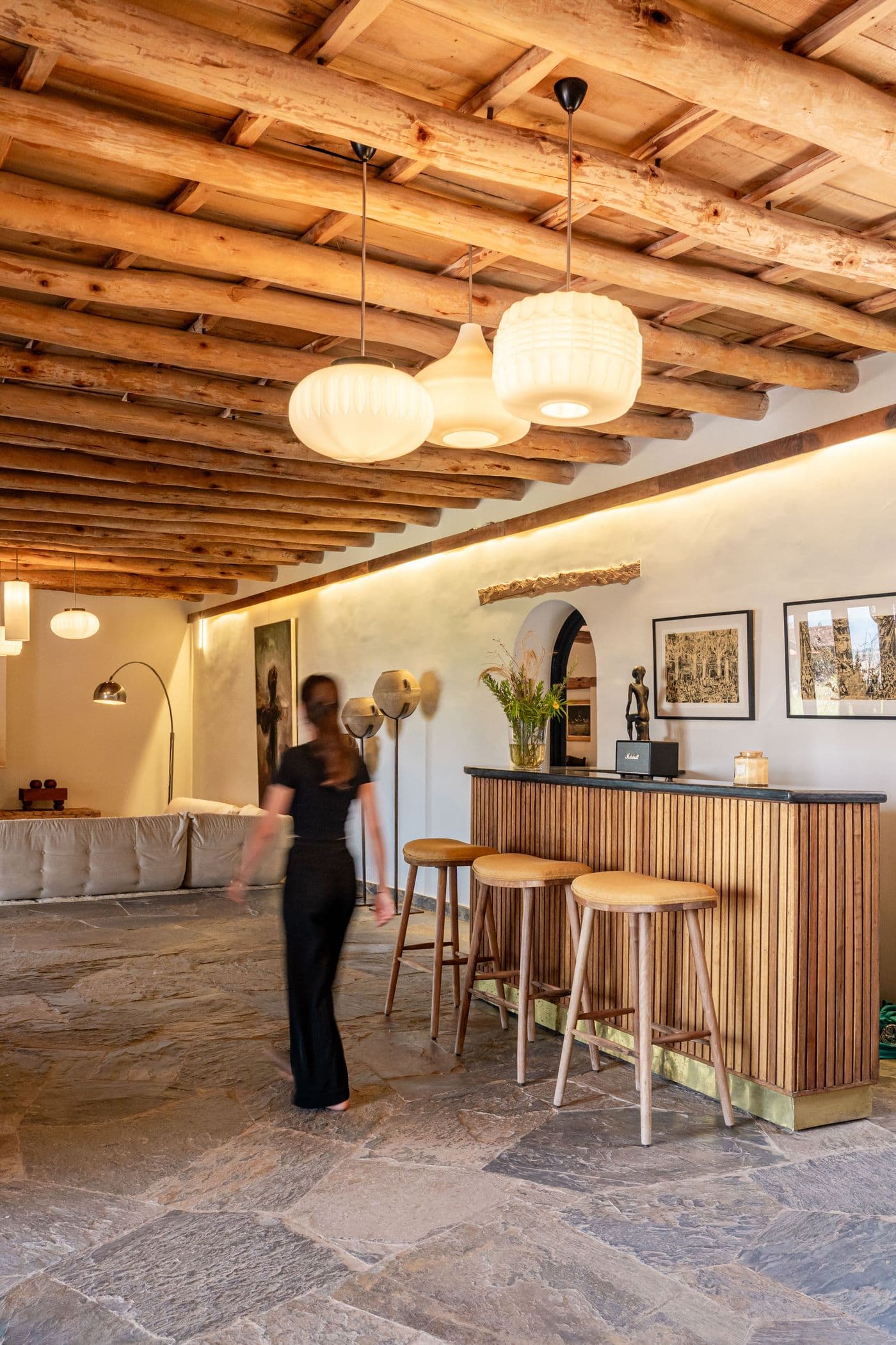Femme derrière le comptoir en bois du bar du Domaine Eladâr